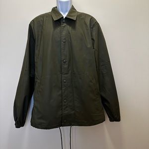 Green rain jacket with tags still on.